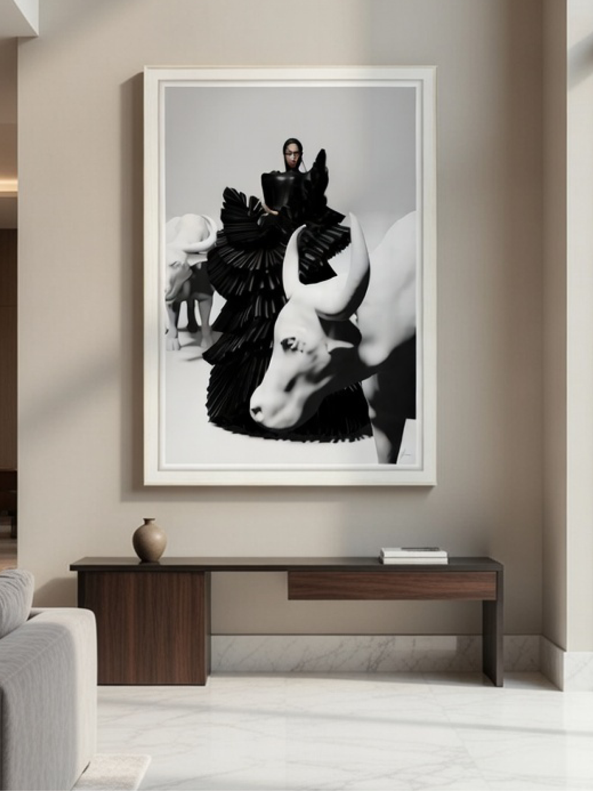High-fashion black and white fine art print in a white frame hanging above a minimalist wooden hallway table.