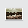 Framed photograph of a rocky landscape with water reflection on a light gray background