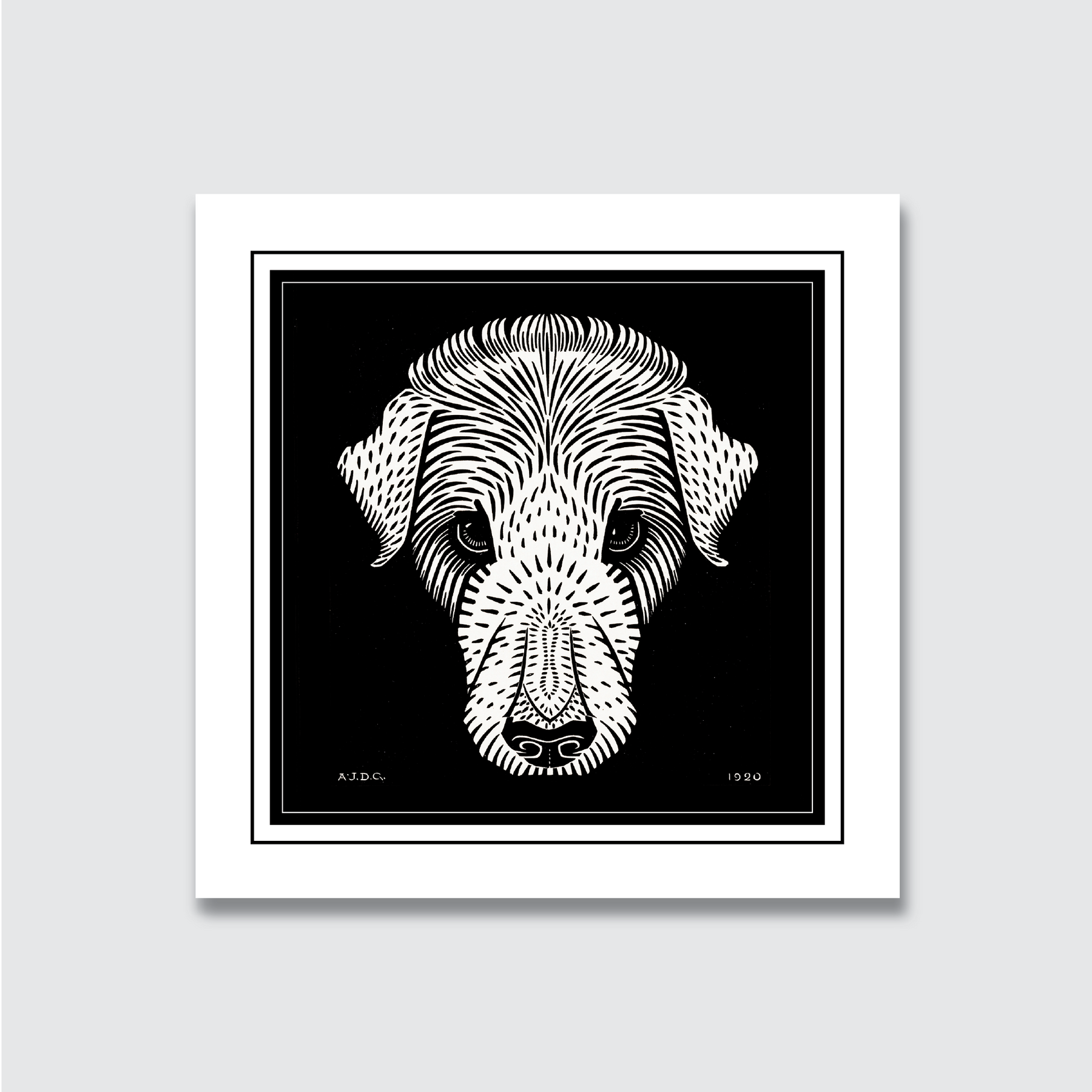 A black and white woodcut print of a dog's head, with the artist's signature 'A.J. de G.' and the date '1920' visible.