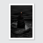 Stunning woman in black long dress standing on a rock with moody background. 