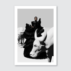 A black and white image featuring a person in a filipino terno standing among sculptural representations of animals, likely a part of a fashion photoshoot or artistic presentation.