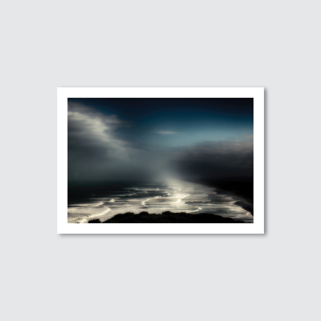 A photograph of Muriwai Beach with a mystical and eerie atmosphere, featuring the sea and coastal terrain.