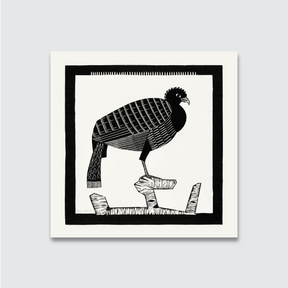 A black and white woodcut print of a peacock perched on a rock, with intricate details and a natural white smooth finish.