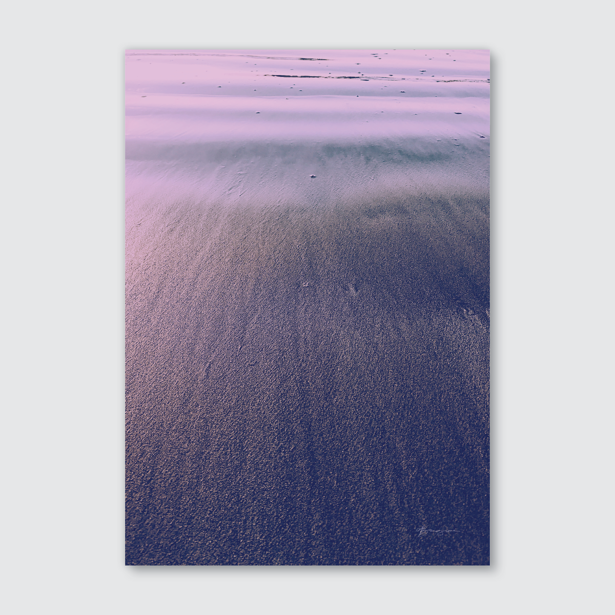 A close-up photograph of natural sand with a smooth, undulating texture, glistening with dew, captured at sunset.