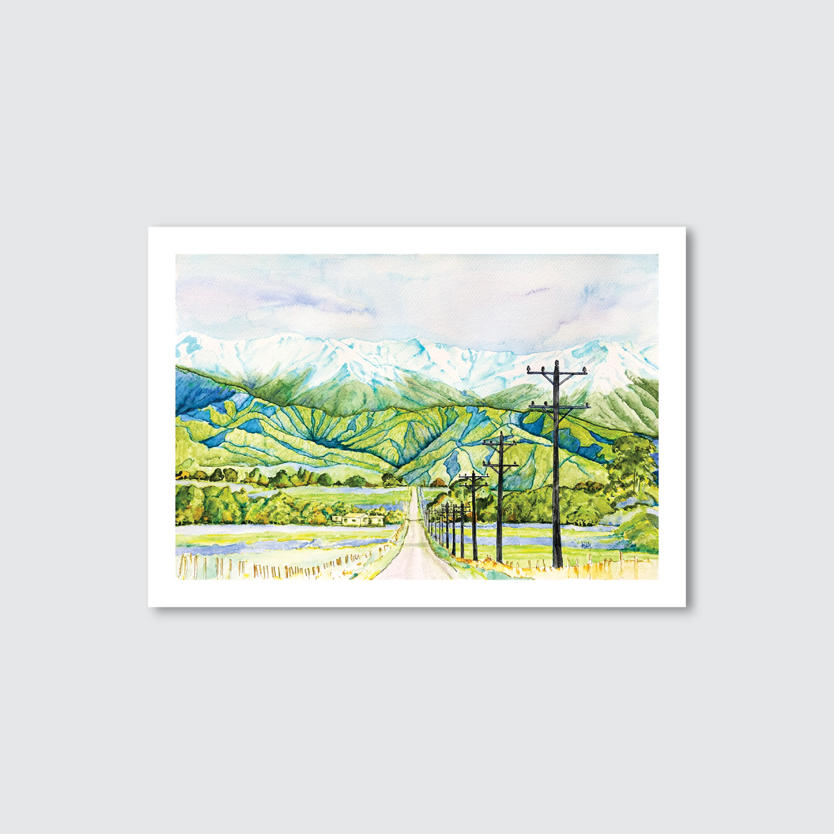 Framed artwork of a scenic landscape with mountains, trees, and a road.
